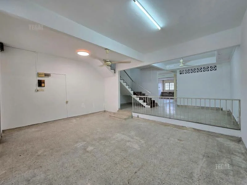 Room features: concrete flooring, white painted walls, ceiling with fluorescent lights, ceiling fan, staircase with railing, large windows for natural light, open layout, no visible furniture; style: minimalist.