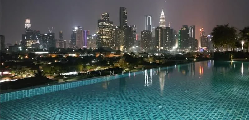 Exterior type: swimming pool deck; features: infinity pool, tiled pool surface, city skyline view, night lighting, surrounding greenery, urban landscape; style: modern.