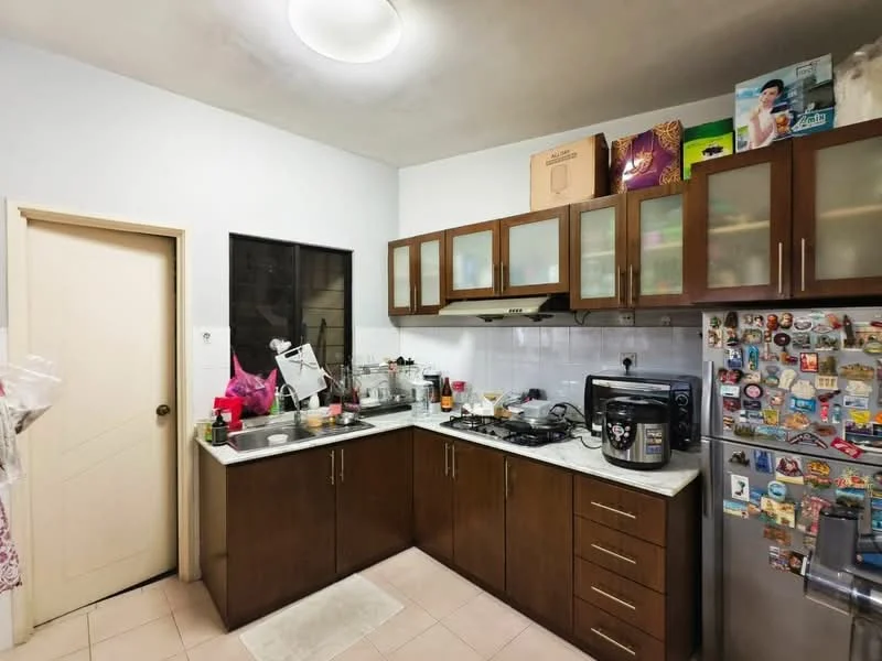 Kitchen features: brown wooden cabinetry, white marble countertop, stainless-steel sink, chrome pull-down faucet, built-in gas stove, microwave, refrigerator with magnets, tile backsplash, cream tiled flooring, overhead cabinets, kitchen appliances on countertop, window above sink, door leading to hallway; style: modern.