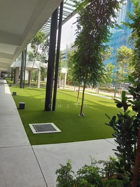 Exterior type: landscape garden; features: manicured lawn, artificial grass, trees with green foliage, concrete pathway, modern landscaping, surrounding greenery, open space, urban setting; style: modern.