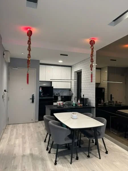 Dining features: round dining table, 4 upholstered dining chairs in grey, white marble tabletop, grey painted walls, wooden flooring, recessed ceiling lights, red decorative lanterns, mirror wall, kitchen area visible in background, black cabinetry, stainless-steel appliances; style: modern.