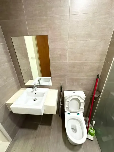 Bathroom features: wall-mounted sink with chrome faucet, square white sink, large wall mirror, one-piece toilet, glass shower enclosure, grey tiled walls, grey tiled flooring, cleaning supplies visible, toilet brush holder, shower with glass door; style: modern.