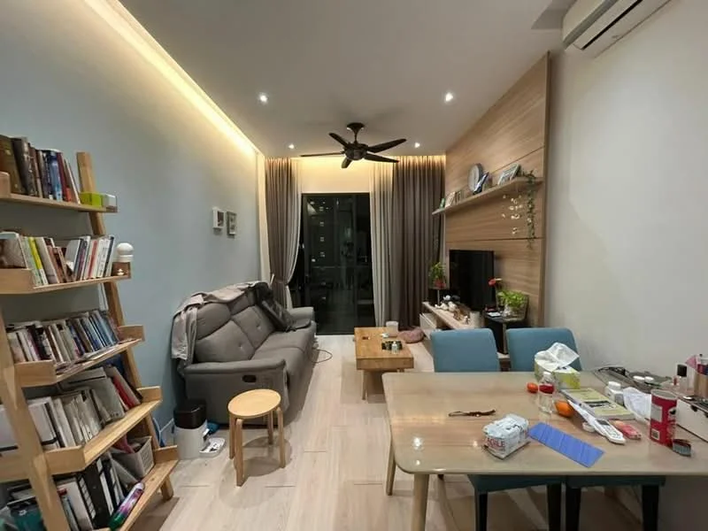 Living features: 3-seater fabric sofa in grey, wooden coffee table, stool, bookshelf with books, TV console, wall-mounted TV, recessed LED downlights, 5-blade ceiling fan with light, curtains, wood panel accent wall, laminate flooring, decorative plants; style: modern; view: city.