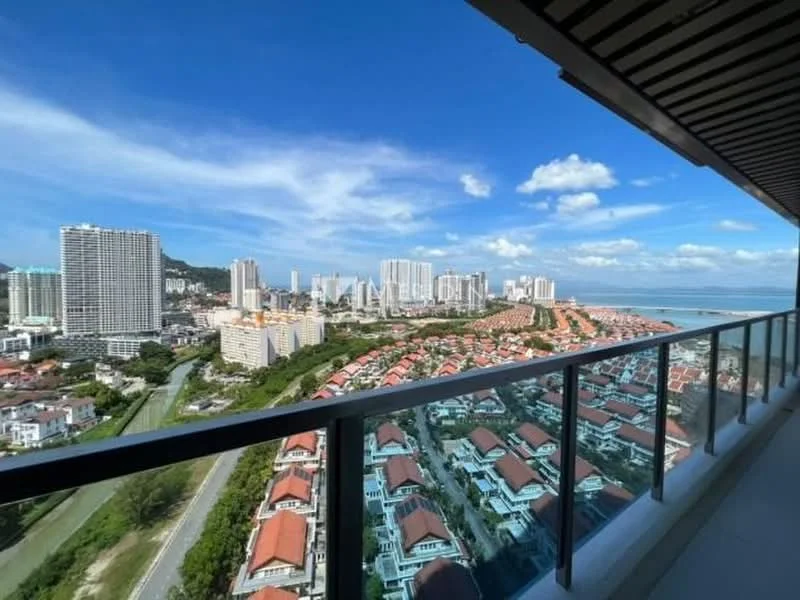 Exterior type: high-rise condominium; features: glass railing balcony, city skyline view, sea view, surrounding residential area, modern architecture, multiple high-rise buildings, greenery along the road, clear blue sky; style: modern.
