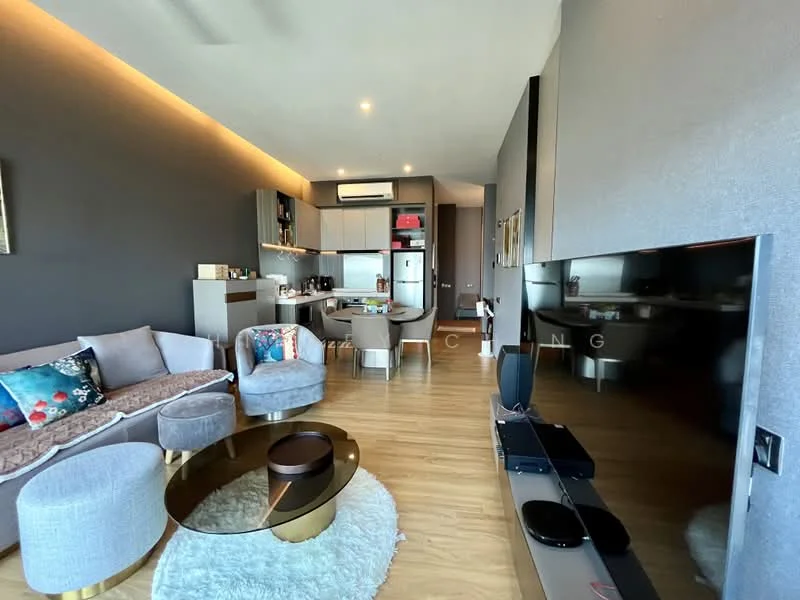 Living features: grey fabric sofa, 2-seater sofa, coffee table with gold trim, area rug, wall-mounted TV, TV console, recessed downlights, wooden flooring, decorative artwork, open shelving, air conditioning unit, kitchenette in background; style: modern.