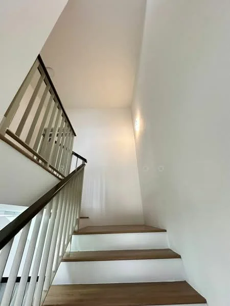 Room features: white painted walls, wooden staircase, glass railing, recessed lighting, natural light from upper level, neutral color palette; style: modern.