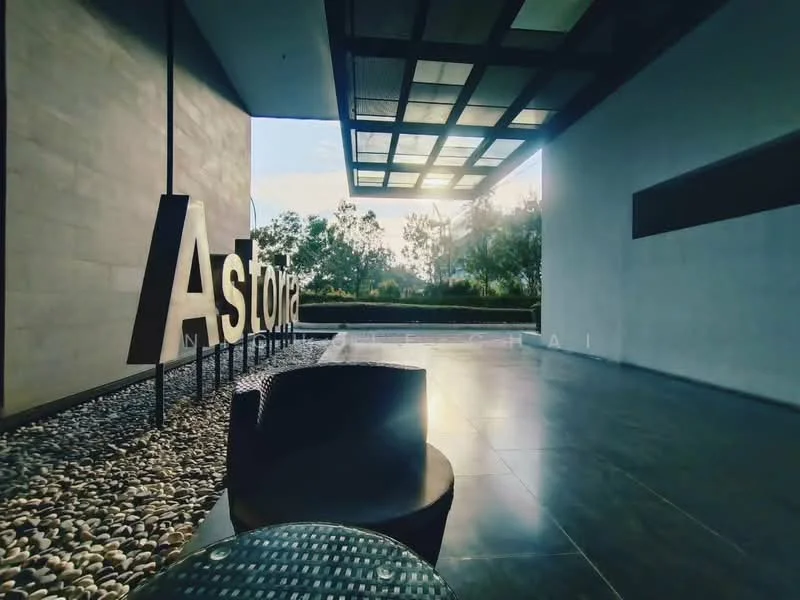 Exterior features: landscaped garden, decorative pebbles, modern signage, glass canopy, concrete facade, outdoor seating area, paved flooring, greenery in background; style: modern.
