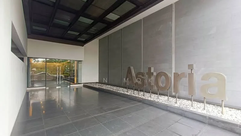 Exterior type: main entrance gate; features: glass entrance doors, stone cladding wall, dark tiled flooring, illuminated signage, landscaped gravel area, modern architectural design, overhanging roof with glass panels; style: modern.