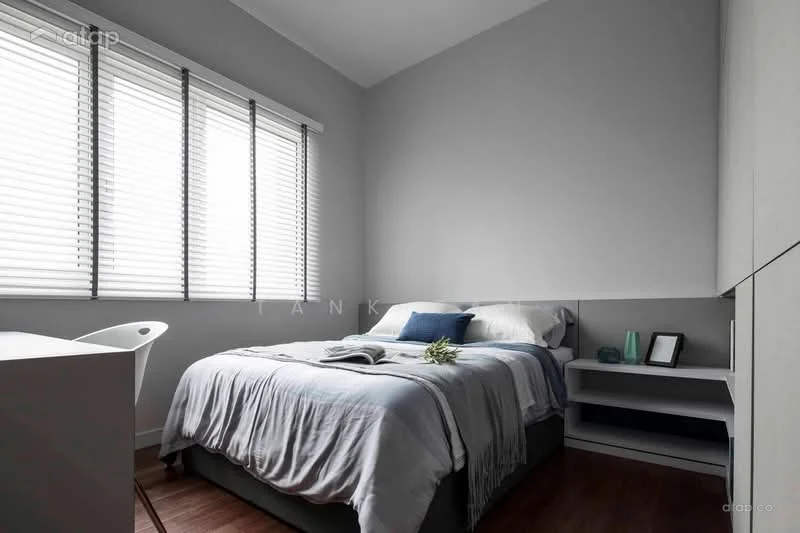 Bedroom features: queen-size bed with grey bedding, upholstered headboard, white walls, wooden flooring, floor-to-ceiling windows, white blinds, nightstand with lamp, decorative plant, study desk, chair; style: modern.