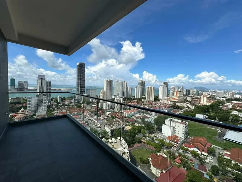 Exterior type: high-rise condominium; features: glass balcony railing, city skyline view, sea view, open-air balcony, tiled flooring, surrounding high-rise buildings, clear blue sky, urban landscape; style: modern.