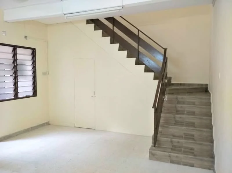 Room features: light beige painted walls, grey tiled flooring, staircase with wooden railing, large window with horizontal slats, door leading to another room, open space layout, ceiling lights, corner space for furniture; style: minimalist.