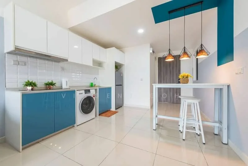 Kitchen features: white upper cabinets, blue lower cabinets, stainless-steel sink, chrome pull-down faucet, built-in oven, freestanding fridge, front-load washing machine, white countertop, tile backsplash, pendant lighting with three fixtures, bar table with stools, ceramic tile flooring, recessed downlights; style: modern.