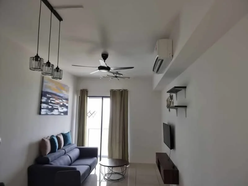 Living features: 3-seater fabric sofa in navy blue, decorative cushions in various colors, coffee table with metal base, wall-mounted TV, floating TV console, ceiling fan with 5 blades, wall-mounted air conditioning unit, floor-to-ceiling sliding glass door, sheer curtains, framed artwork on wall, glossy tile flooring, recessed lighting; style: modern; view: city.