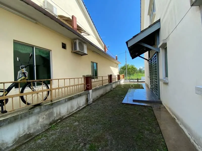 Exterior features: bicycle parked, concrete walkway, grassy area, air conditioning unit on wall, side entrance with awning, windows with green tint.