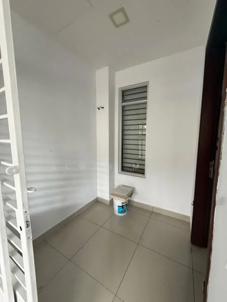 Room features: white painted walls, tile flooring, single window with metal grille, light fixture on ceiling, door leading outside, corner space, paint bucket on floor.