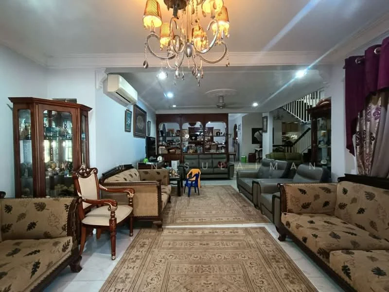 Living features: chandelier, 5-blade ceiling fan, cream painted walls, white ceiling, wall-mounted air conditioning unit, sofa set with floral pattern upholstery, armchair with wooden frame, coffee table, area rug with intricate pattern, display cabinets with glass doors, decorative wall art, curtains with floral pattern, open shelving unit, wooden staircase in background; style: traditional.