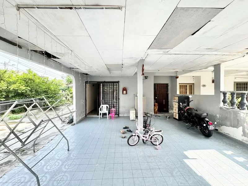 Exterior type: linked terrace house; features: open patio area, grey tiled flooring, partially covered ceiling, metal railing, motorcycle parked, children's bicycle, outdoor furniture, garden visible in background; style: modern.
