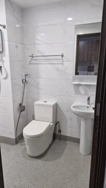 Bathroom features: white tiled walls with marble pattern, grey floor tiles, one-piece toilet, chrome basin mixer faucet, pedestal sink, shower with handheld showerhead, mirror above sink, towel rack, wall-mounted water heater; style: modern.