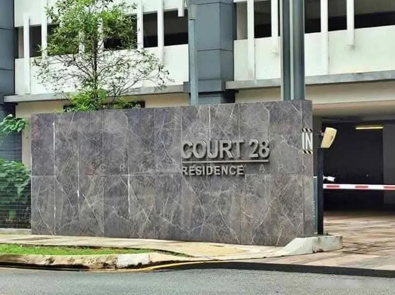 Exterior features: stone cladding facade, signage with 'COURT 28 RESIDENCE', landscaped area with grass, tree in vicinity, parking entrance, modern architectural design; style: modern.