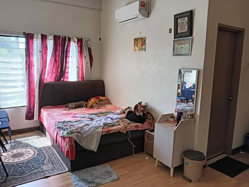 Bedroom features: queen-size bed with pink bedding, wall-mounted split AC, floor-to-ceiling window with sheer curtains, wooden flooring, decorative wall art, mirror on dresser, small bedside table, area rug with geometric pattern, clothing on bed.