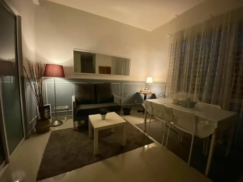 Living features: grey fabric sofa, white coffee table, area rug with geometric pattern, floor lamp with shade, table lamp, mirrored wall, curtains, white dining table with chairs, decorative plants, wall paneling, recessed lighting; style: modern.