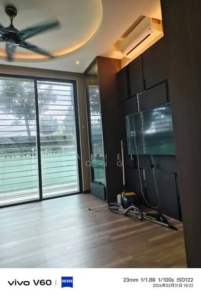 Room features: large floor-to-ceiling windows, wooden flooring, recessed ceiling with lighting, dark wood paneling, TV mounted on wall, vacuum cleaner visible, sliding glass door, greenery view outside; style: modern; view: garden.