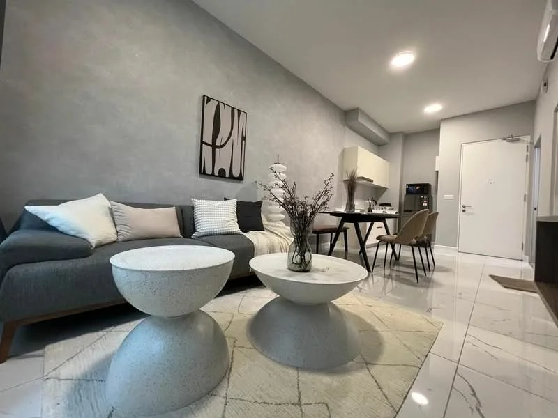Living features: grey fabric sectional sofa, two round coffee tables in white, area rug with geometric pattern, wall-mounted air conditioning unit, recessed ceiling lights, decorative wall art, dining table with chairs, white marble flooring; style: modern.