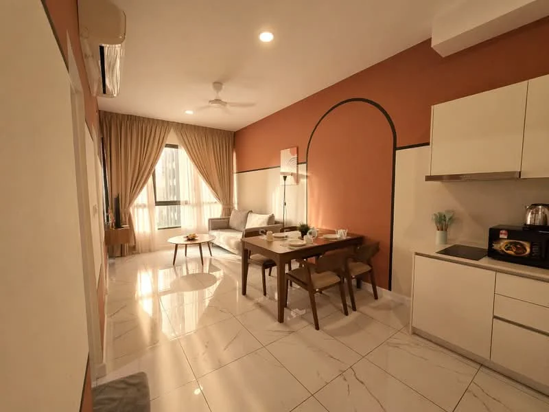 Living features: cream painted walls, orange accent wall, marble tile flooring, 5-blade ceiling fan with light, floor-to-ceiling windows, sheer curtains, sofa in light grey fabric, wooden dining table, 4 dining chairs, kitchenette with white cabinetry, stainless-steel kettle, microwave, decorative plants, area rug with circular pattern; style: modern; view: city.