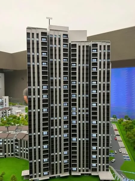 Exterior type: high-rise condominium; features: glass curtain wall, grey painted facade, recessed balconies, vertical fins, multiple storeys, surrounded by landscaped area, parking area visible, urban context; style: modern.