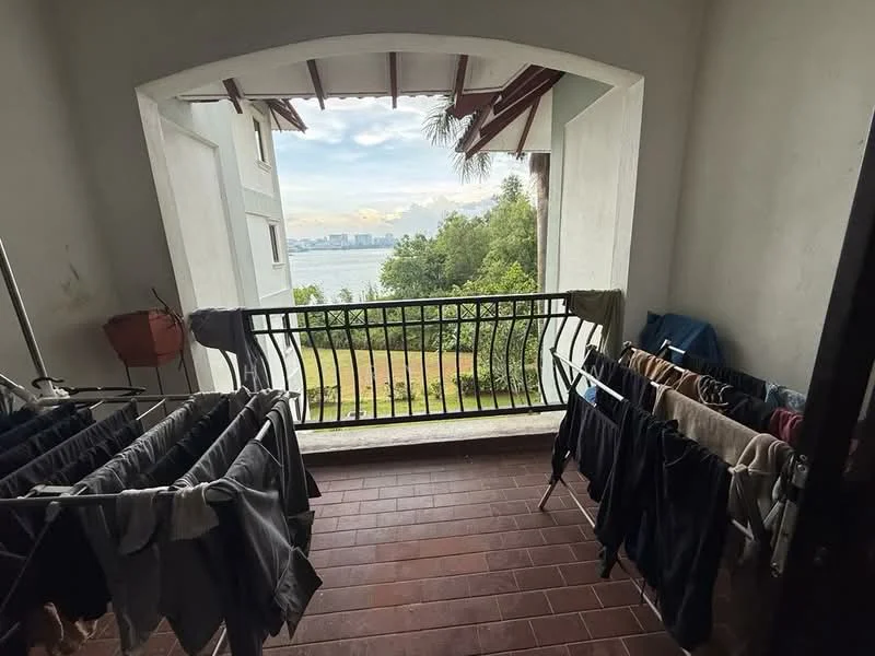 Balcony features: terracotta tile flooring, metal railing, overhead roof with wooden beams, clothes drying rack, view of greenery, view of water, city skyline in distance; view: sea.