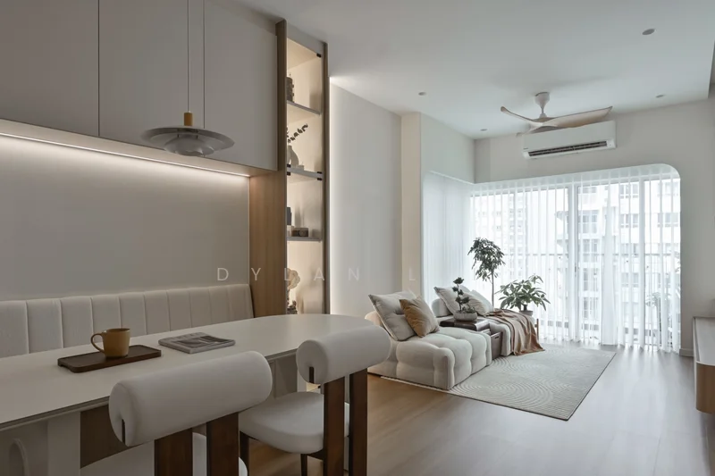 Living features: light wood flooring, white painted walls, ceiling fan with light, floor-to-ceiling windows, sheer curtains, sofa with multiple cushions, area rug, dining table with white chairs, built-in shelving unit with decorative items, potted plants; style: modern; view: city.