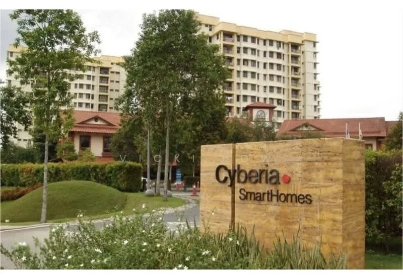 Exterior type: high-rise condominium; features: landscaped garden, manicured lawn, mature trees, signage with 'Cyberia SmartHomes', multi-storey building, surrounded by greenery; style: modern.