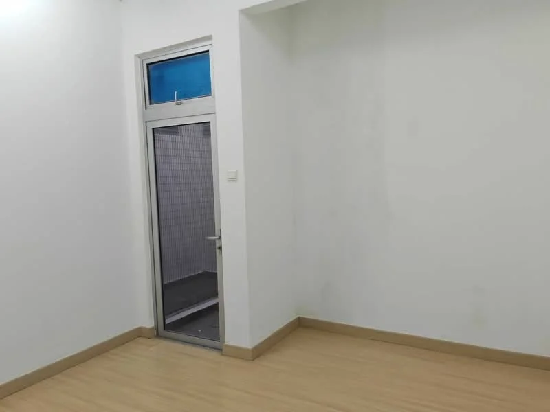 Room features: white painted walls, laminate flooring, single door, window with blue glass, corner room.
