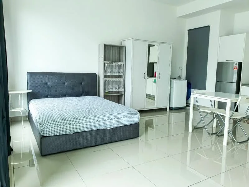 Room features: queen-size bed with grey upholstered headboard, white bed linens with blue checkered pattern, white tiled flooring, white walls, large wardrobe with mirrored doors, small dining table with four chairs, refrigerator, washing machine, open shelving unit, window with black curtains, ceiling light fixture; style: modern.