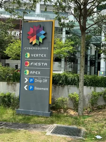 Exterior features: signage with multiple names, landscaped greenery, paved walkway, parking direction indicators, drop-off area indication, basement parking indication; style: modern.