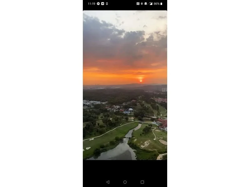 Exterior features: sunset view, golf course, lush greenery, water body, hills in background, urban skyline in distance.