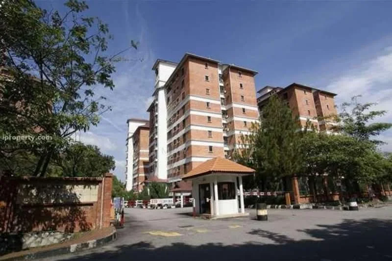 Exterior type: mid-rise condominium; features: red brick facade, flat roof, approximately 5-storey building, guard house at entrance, gated entry, manicured landscaping, surrounded by trees, parking area visible; style: modern.