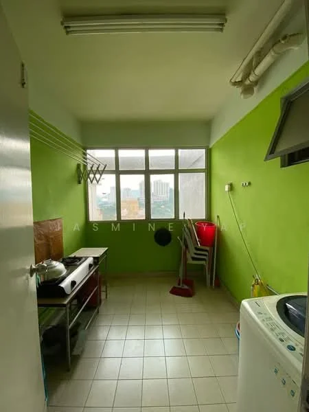 Kitchen features: green painted walls, white tiled flooring, stainless-steel gas stove, metal kitchen cart, window with city view, washing machine, plastic chairs, clothes drying rack, broom, mop, sink with faucet; view: city.