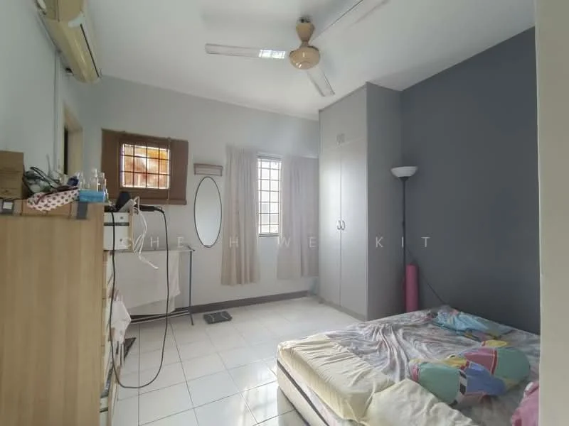 Bedroom features: white painted walls, grey accent wall, tile flooring, ceiling fan, built-in wardrobe, mirror, floor lamp, window with grid, bed with colorful bedding, curtains, nightstand.