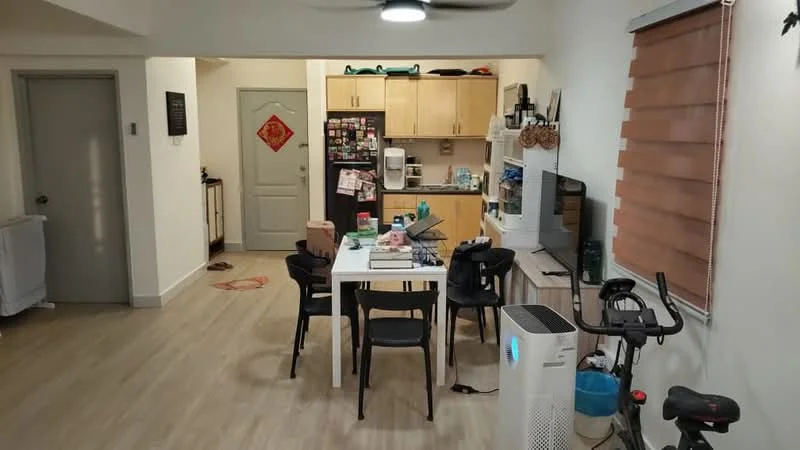 Living features: light wood laminate flooring, white painted walls, ceiling fan with light, dining table with four black chairs, TV console, wall-mounted TV, refrigerator, built-in kitchen cabinets, countertop with kitchen appliances, decorative wall art, window with roller blinds, exercise bike, air purifier; style: modern.