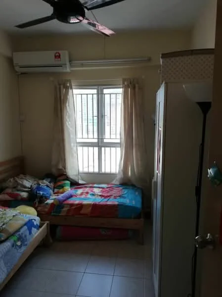 Bedroom features: two single beds with colorful bedding, wall-mounted air conditioning unit, window with metal grille, curtains, light-colored walls, tile flooring, wooden bed frames, wardrobe, floor lamp.