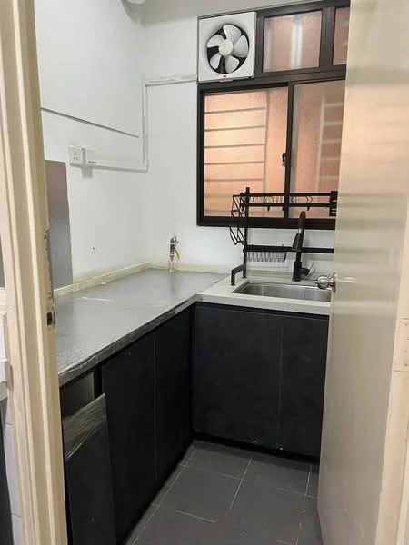 Kitchen features: grey laminate cabinetry, stainless-steel sink, chrome faucet, countertop with grey surface, wall-mounted fan, window with black frame, tile flooring, dish rack; style: modern.