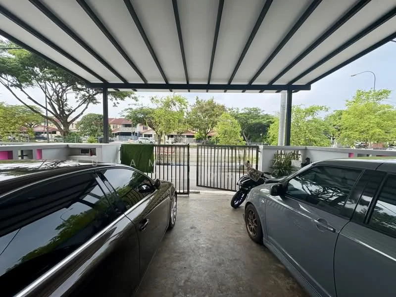 Exterior type: car porch; features: covered car porch with metal roofing, concrete flooring, gated entrance, two parked cars, motorcycle parked, surrounded by greenery, view of residential area; style: modern.