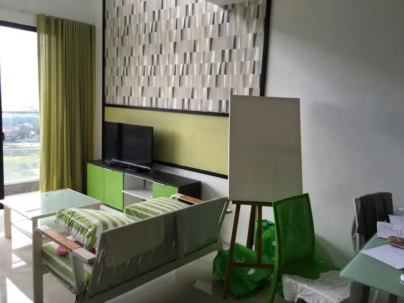 Living features: green and white striped sofa, glass coffee table, TV console in white and green, wall-mounted TV, floor-to-ceiling windows, sheer curtains, green accent wall, decorative wall panel with geometric pattern, green plastic chair, easel, white flooring, area rug; style: modern; view: city.