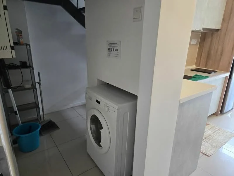 Laundry features: front-load washing machine, white walls, tile flooring, open shelving, utility area, corner space, near kitchen, light-colored cabinetry; style: modern.