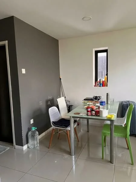 Dining features: glass dining table, 4 dining chairs in white and green, grey accent wall, white painted walls, tile flooring, small window with view, decorative items on window sill, bottled water, canned goods on table; style: modern.