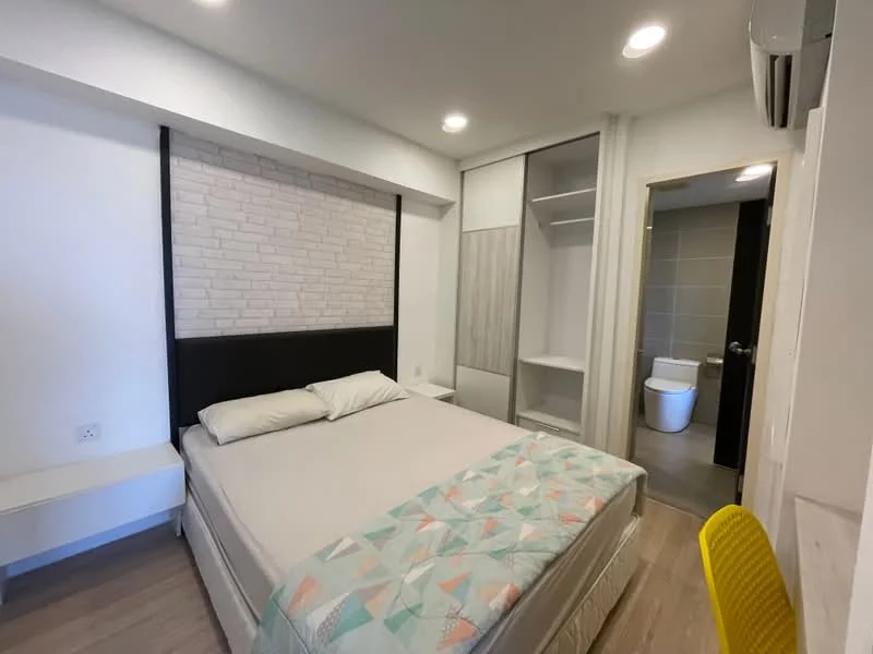 Bedroom features: queen-size bed, upholstered headboard, white bedding, light wood flooring, white painted walls, feature wall with stone cladding, built-in wardrobe with sliding doors, air conditioning unit, wall-mounted light fixtures, yellow chair, open shelving, en-suite bathroom door; style: modern. Bathroom features: one-piece toilet, grey tiled flooring, grey wall tiles, shower area, vanity with mirror.
