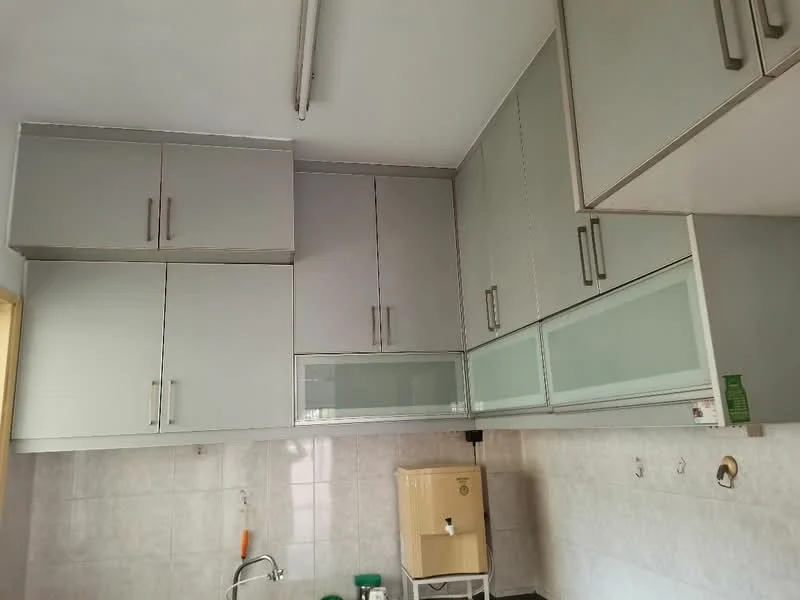 Kitchen features: grey cabinetry with glass-front upper cabinets, white tiled backsplash, stainless-steel sink, chrome faucet, under-cabinet lighting, wall-mounted water heater, countertop space, multiple storage cabinets; style: modern.
