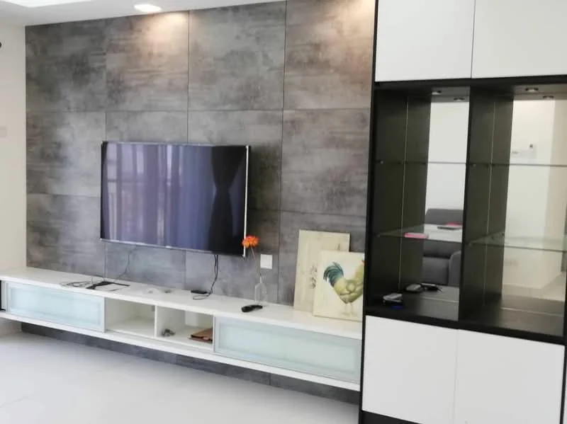 Living features: grey accent wall, flat-screen TV mounted on wall, white media console with glass doors, decorative artwork on floor, glass display cabinet, light-colored flooring, recessed lighting, open shelving; style: modern.