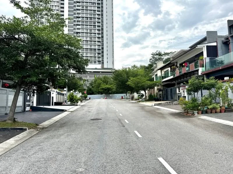 Exterior type: linked terrace house; features: tree-lined street, manicured landscaping, paved road, multi-storey high-rise in background, residential houses with balconies, visible parking spaces, flower pots along the walkway, surrounding greenery; style: modern.